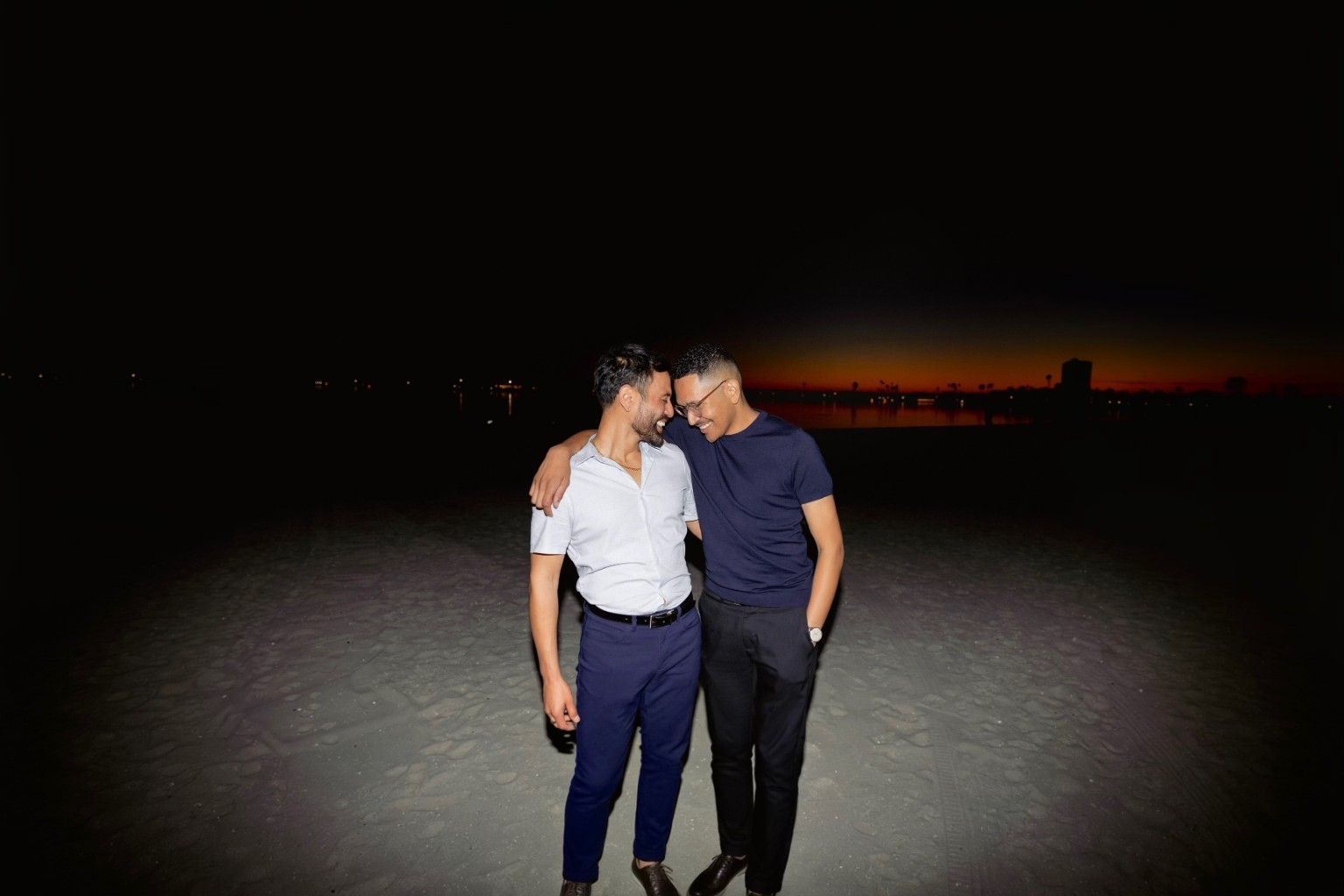 Jorge and Simone together on the beach at night
